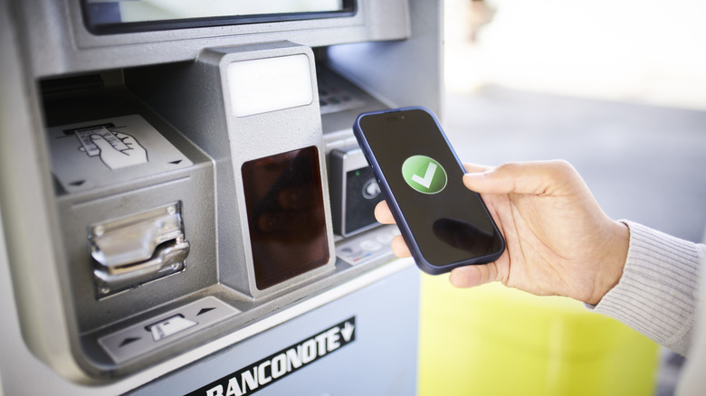 Person using contactless payment at gas pump