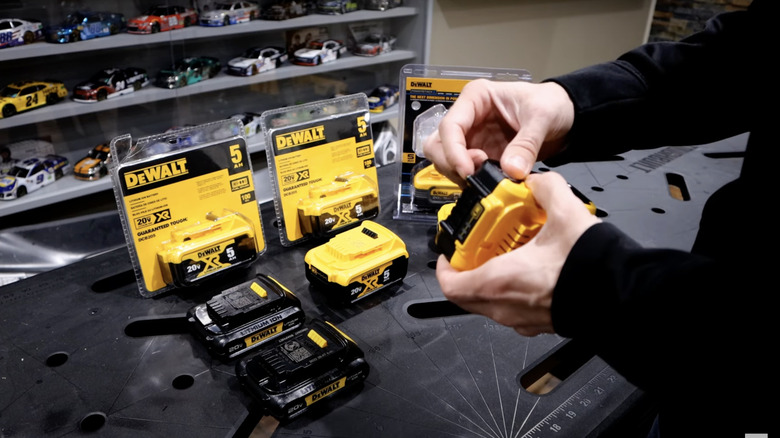 man with multiple DeWalt batteries