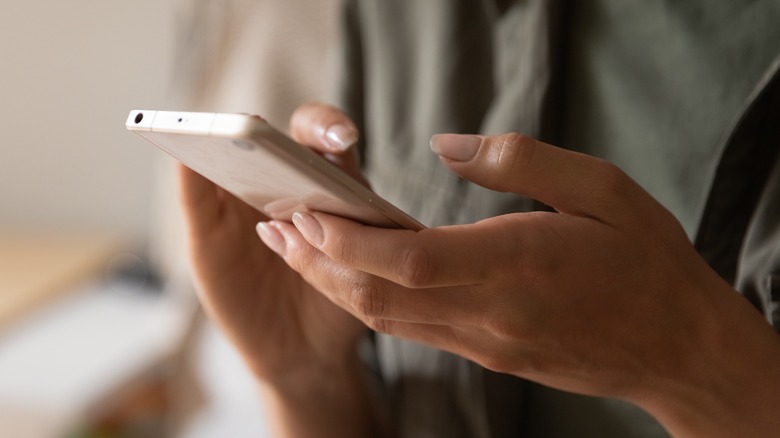 hands holding smartphone