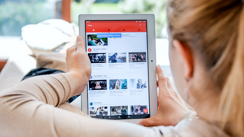 woman watching YouTube on tablet