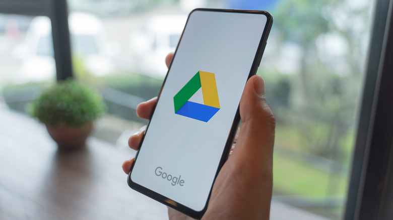 person holding phone with google drive app