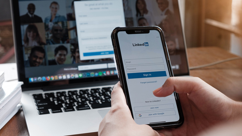 LinkedIn displayed on smartphone and laptop