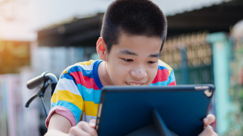 A disabled child using an iPad