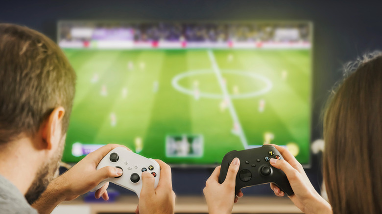 Two playing soccer game on Xbox