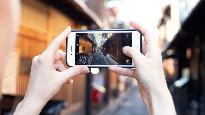 person taking photo on iphone