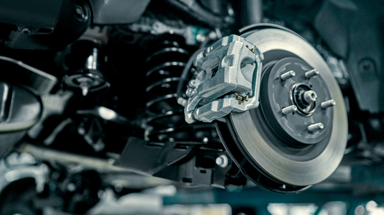 A smaller rear brake disc with a silver caliper