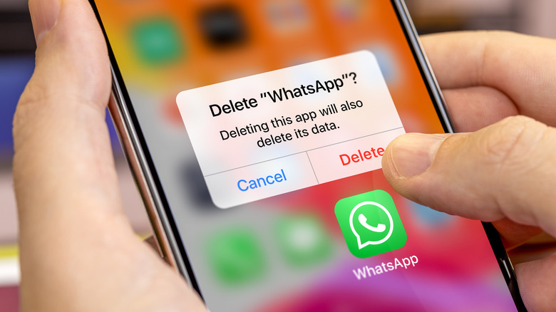 Person deleting WhatsApp from their iPhone