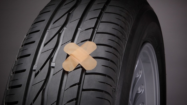 Tire with cross-shaped patch