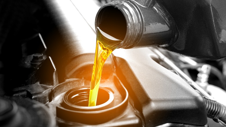 Pouring oil into car