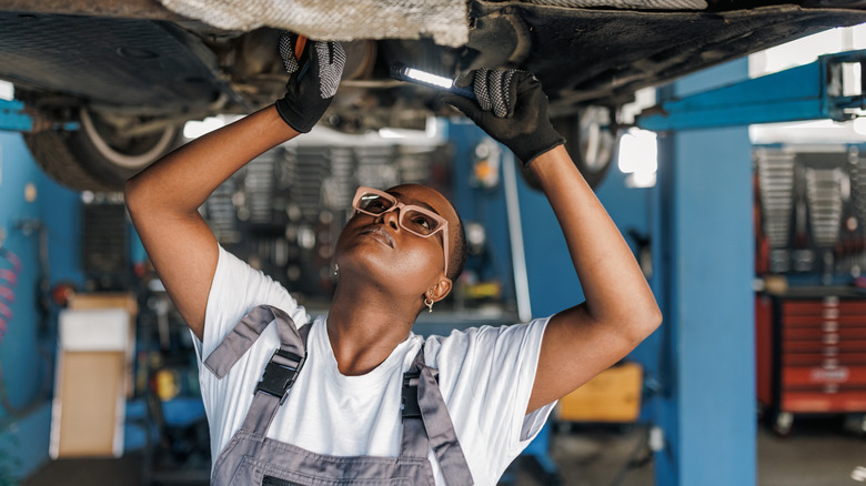 Person working on raised car