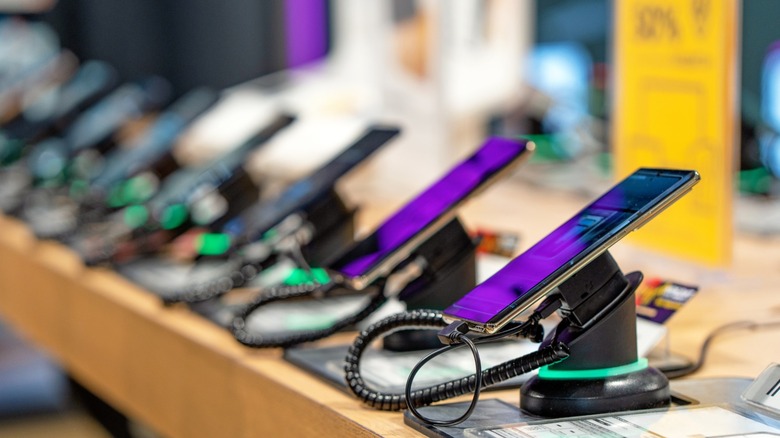 Smartphones lined up at a phone store