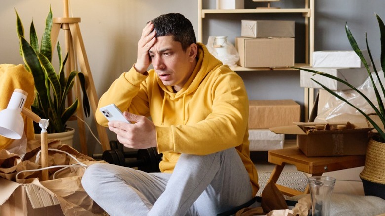 A man steering at his phone