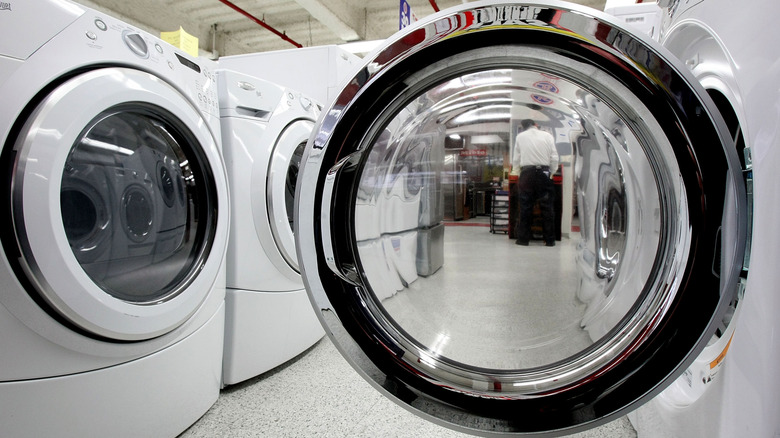 Clothes dryers lined up for display in a store