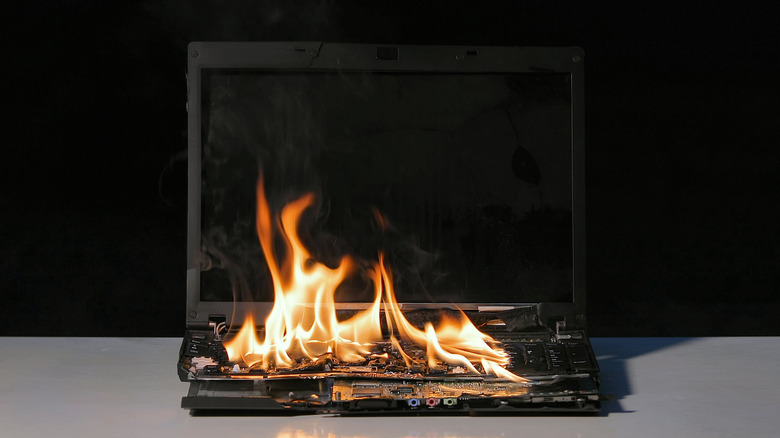 Burning laptop on table