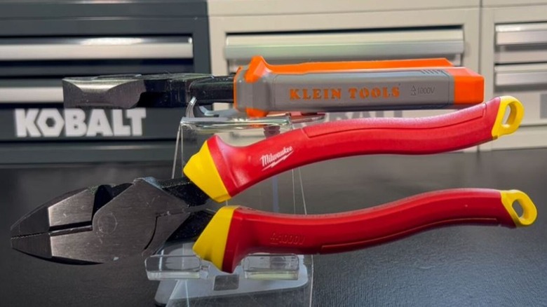 Two insulated electrical pliers on display