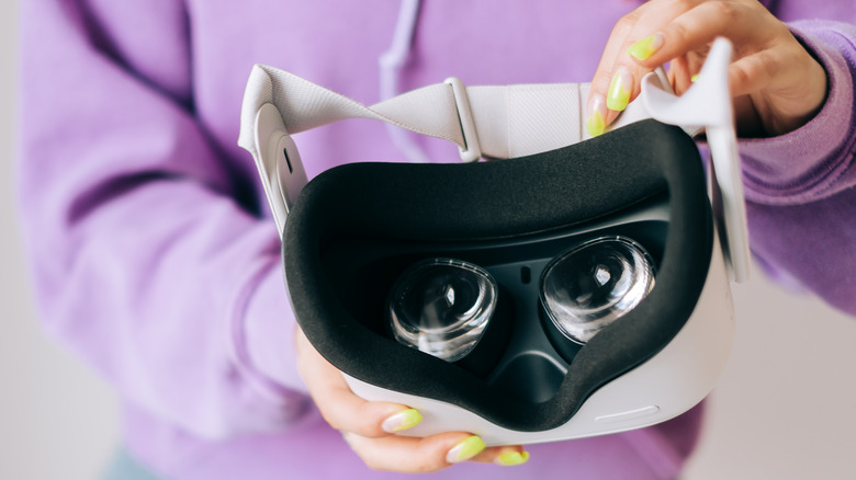 woman holding Oculus headset