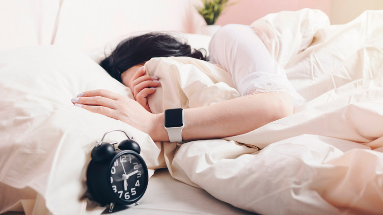 girl sleeping with apple watch on hand