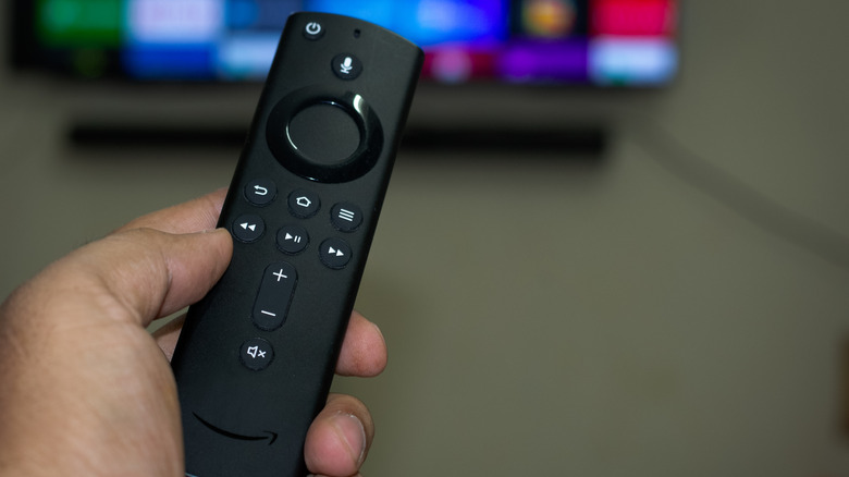 Hand holding Fire TV Stick remote