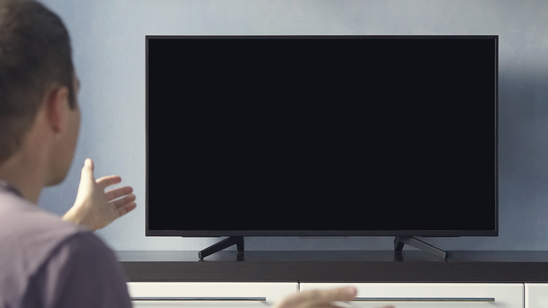 Person frustrated with TV black screen