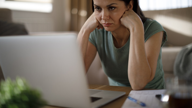 person frowning at laptop