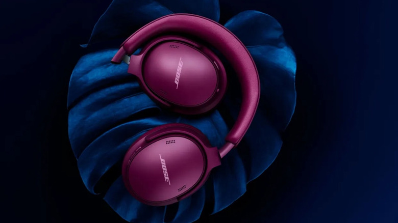 The Bose QuietComfort Headphones (2nd Gen) in Rosewood Mauve is laying on top of a leaf
