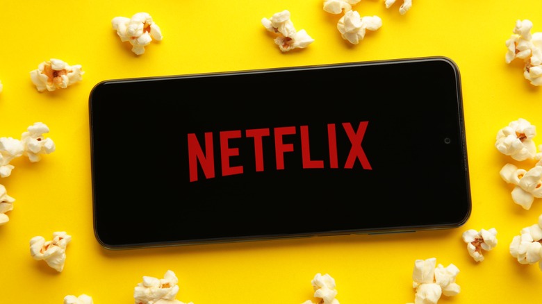 Netflix on smartphone with popcorn