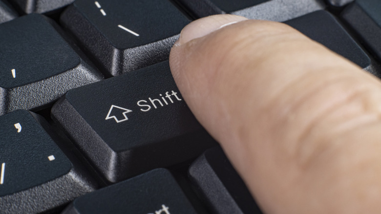 person pushing Shift key