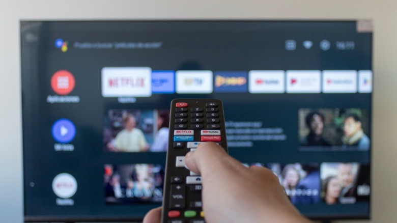 Person controlling a smart TV using a remote