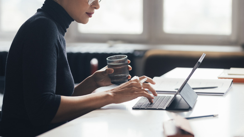 woman typing on tablet with keyboard companion