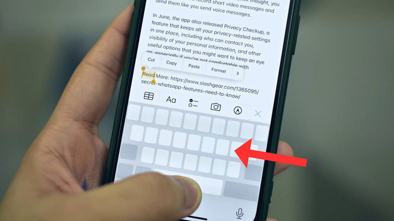 Trackpad mode of iPhone's keyboard with an arrow next to it