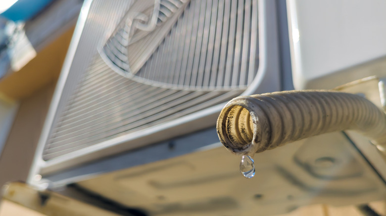 Water dripping from the drain pipe of the outdoor unit of the air conditioner.