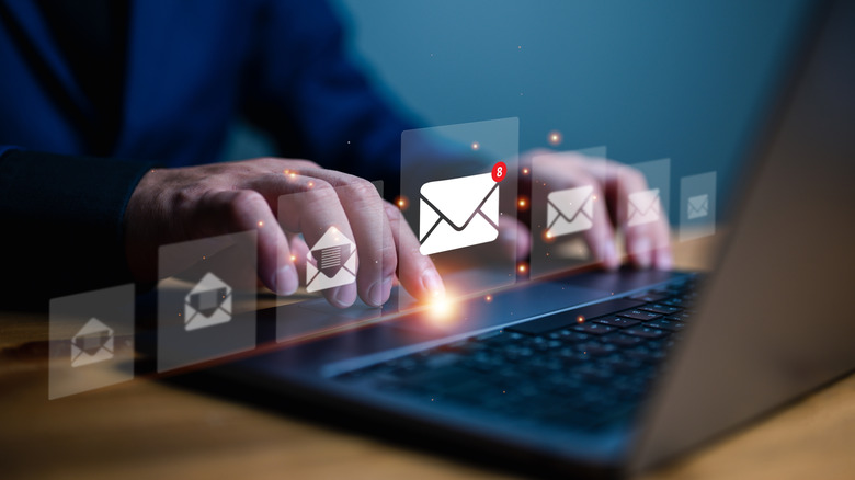 Email icons set against a background of someone typing on a laptop.