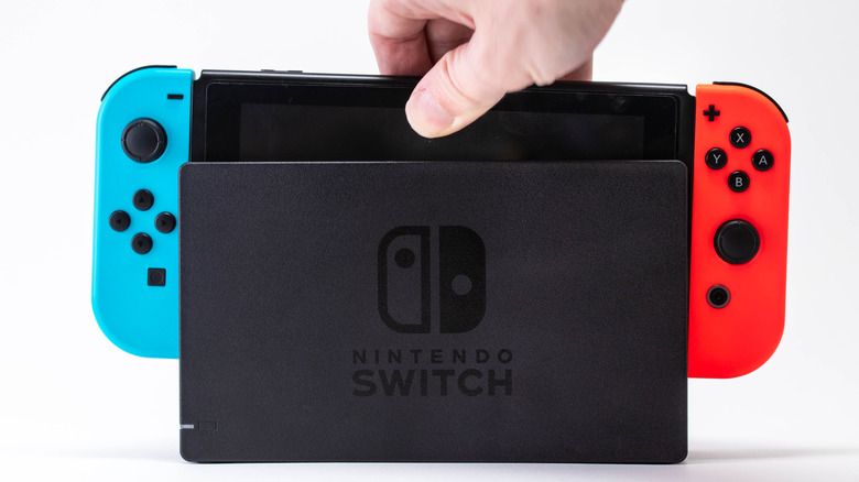 hand putting Switch in dock
