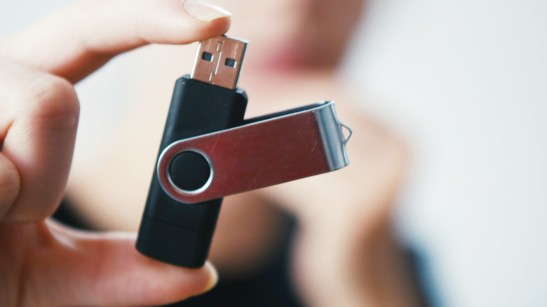 hand holding an open USB thumb drive