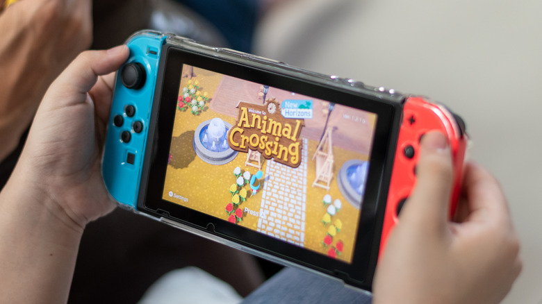 Nintendo Switch consoles in hands