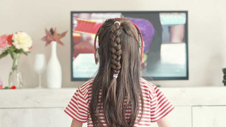 Kid watching TV with headphones