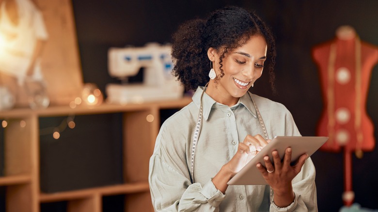 woman holding tablet and smiling