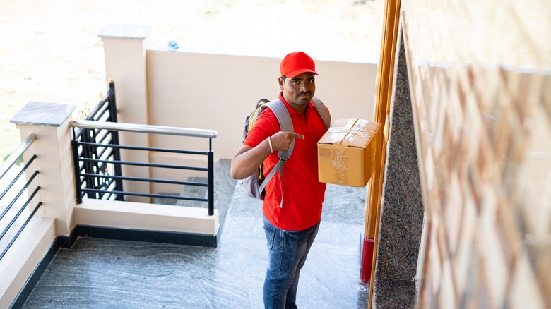delivery man looking at security camera