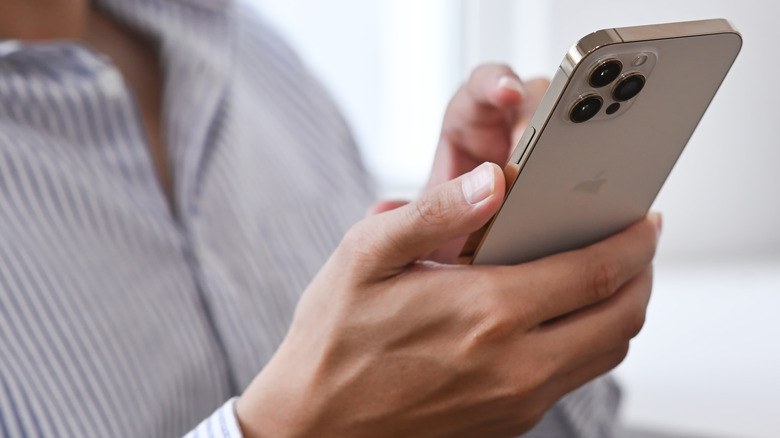 man holding iphone 12