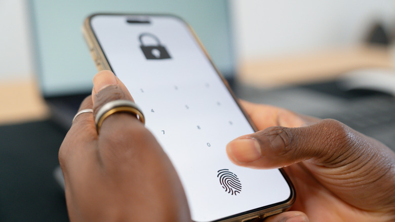 A person unlocking their smartphone, with the option of either fingerprint or PIN