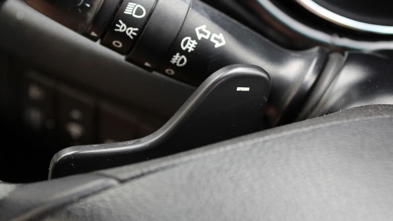 Close up on paddle shifter on steering wheel
