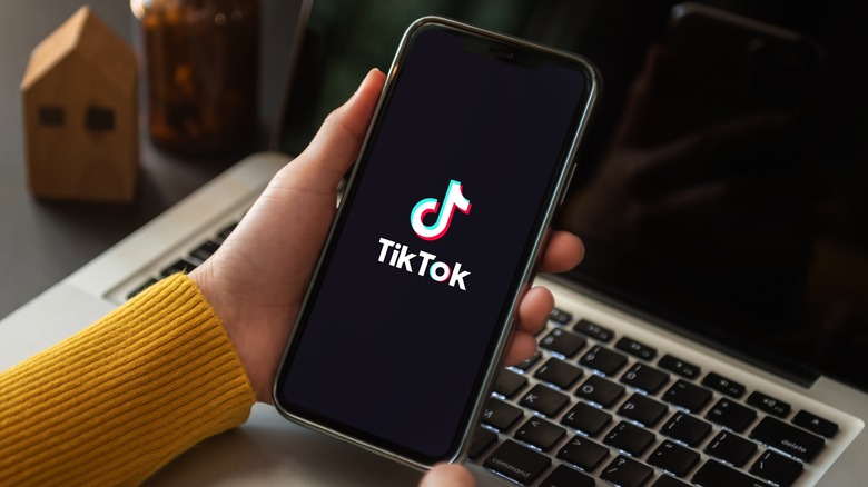 woman opening TikTok smartphone