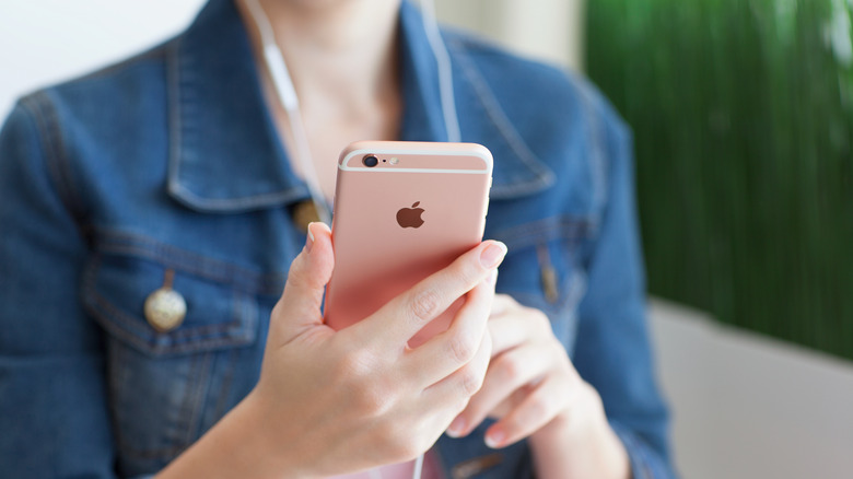 woman using earpods on iphone