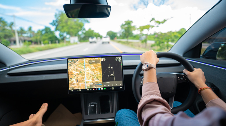 Woman driving an EV on the road