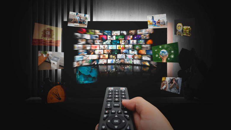 Person using remote to scroll through live tv channels