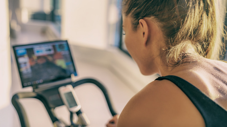 Person on exercise bike with screen