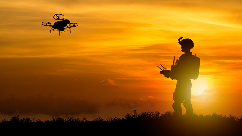 A soldier flying a drone