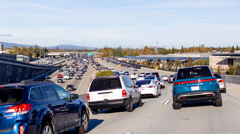 Busy traffic on the lanes of a big road.