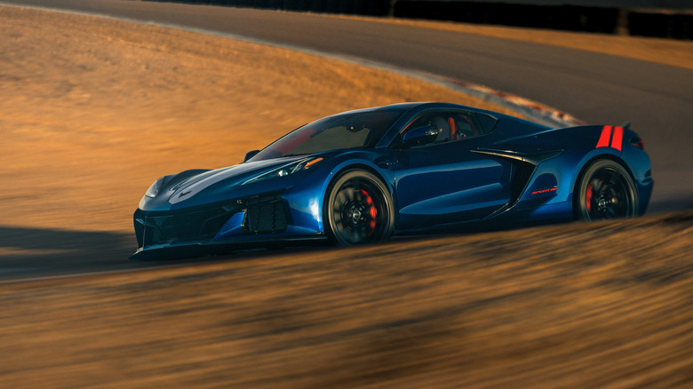 Blue and red C8 Chevy Corvette Grand Sport driving through corner on race track.