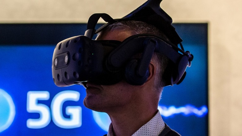 HTC VR headset on person near 5G logo